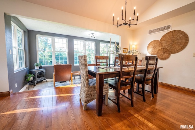 623 Jasper Rd, Centralia, IL 62801 - dining room with hardwood / wood-style flooring, a chandelier, a wood stove, and lofted ceiling