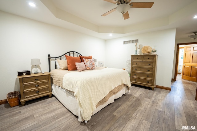 623 Jasper Rd, Centralia, IL 62801 - bedroom featuring a tray ceiling, light wood-style flooring, recessed lighting, and ceiling fan