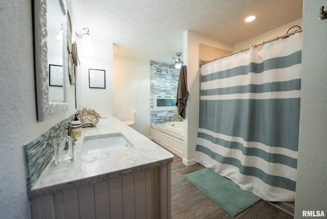 623 Jasper Rd, Centralia, IL 62801 - full bath featuring a textured ceiling, wood finished floors, vanity, a shower with shower curtain, and recessed lighting