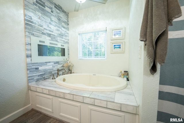 623 Jasper Rd, Centralia, IL 62801 - full bathroom featuring a garden tub, wood finished floors, and a textured wall