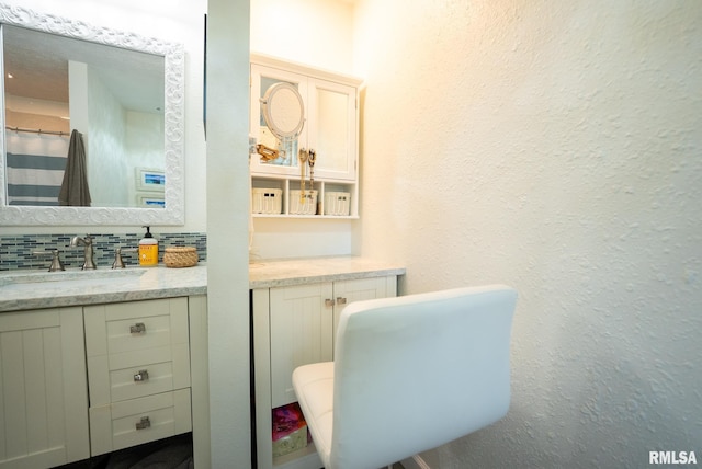 623 Jasper Rd, Centralia, IL 62801 - bathroom featuring vanity and decorative backsplash