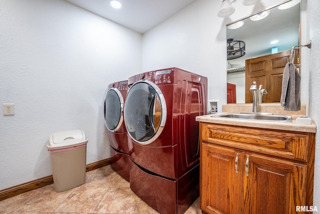 623 Jasper Rd, Centralia, IL 62801 - washroom featuring washing machine and dryer, light tile patterned flooring, and cabinet space