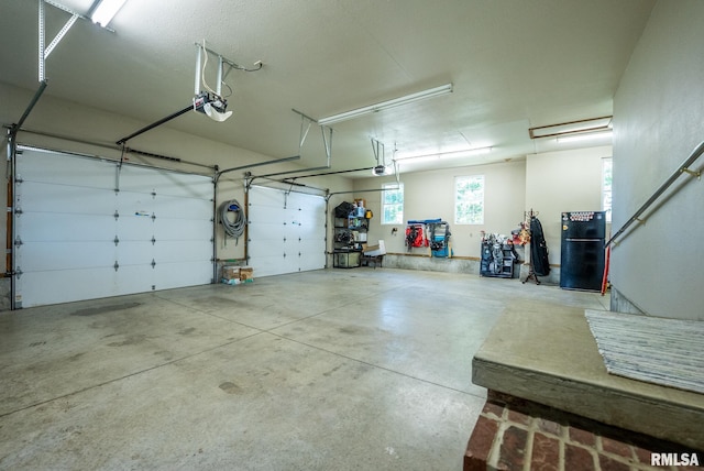 623 Jasper Rd, Centralia, IL 62801 - garage featuring freestanding refrigerator and a garage door opener