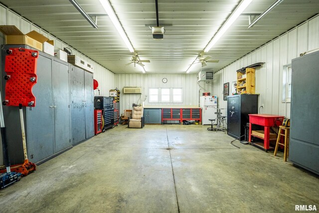 623 Jasper Rd, Centralia, IL 62801 - garage featuring freestanding refrigerator, ceiling fan, a workshop area, and a wall mounted AC