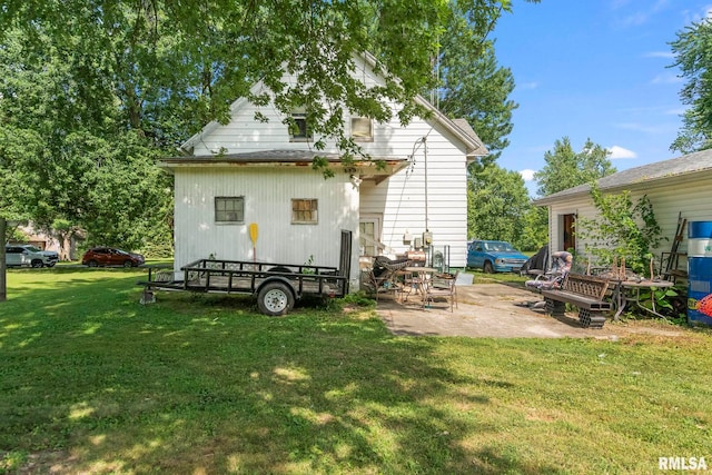 215 N Wilson St, Girard, IL 62640 - back of house featuring a yard and a patio
