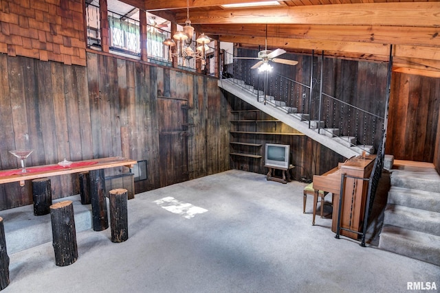 107 E Harrison St, Edinburg, IL 62531 - basement featuring wooden walls, stairs, carpet floors, a chandelier, and a ceiling fan