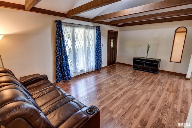107 E Harrison St, Edinburg, IL 62531 - unfurnished living room with beamed ceiling and wood finished floors
