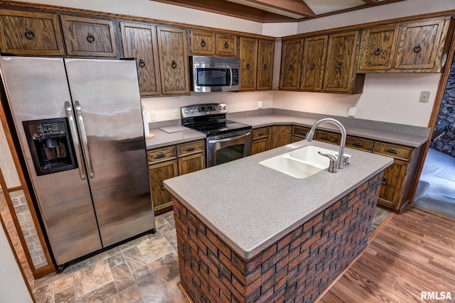 107 E Harrison St, Edinburg, IL 62531 - kitchen with appliances with stainless steel finishes, light countertops, and a kitchen island with sink
