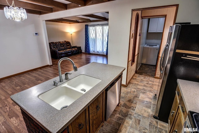 107 E Harrison St, Edinburg, IL 62531 - kitchen with appliances with stainless steel finishes, open floor plan, beam ceiling, a chandelier, and light countertops