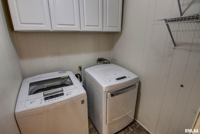 107 E Harrison St, Edinburg, IL 62531 - laundry room with cabinet space, washer and dryer, and wood walls
