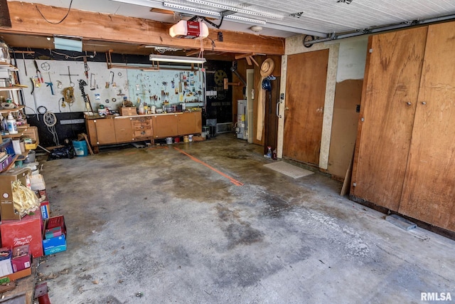107 E Harrison St, Edinburg, IL 62531 - garage with a workshop area, a garage door opener, and gas water heater