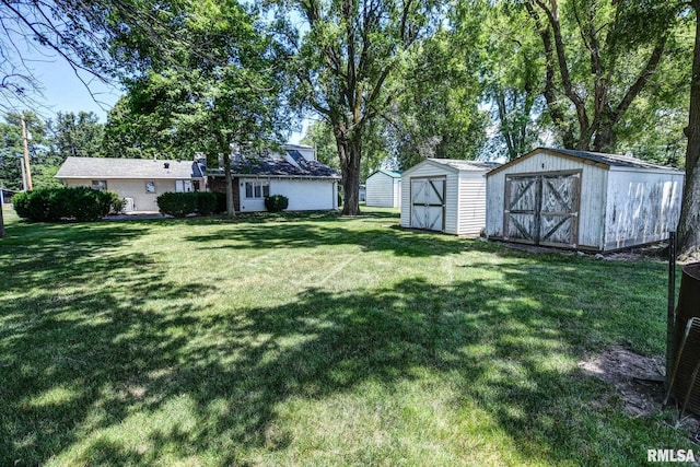 107 E Harrison St, Edinburg, IL 62531 - view of grassy yard featuring a storage unit