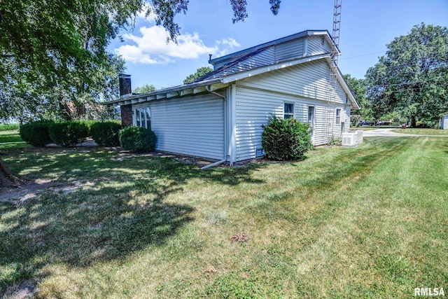 107 E Harrison St, Edinburg, IL 62531 - view of home's exterior with a chimney and a yard