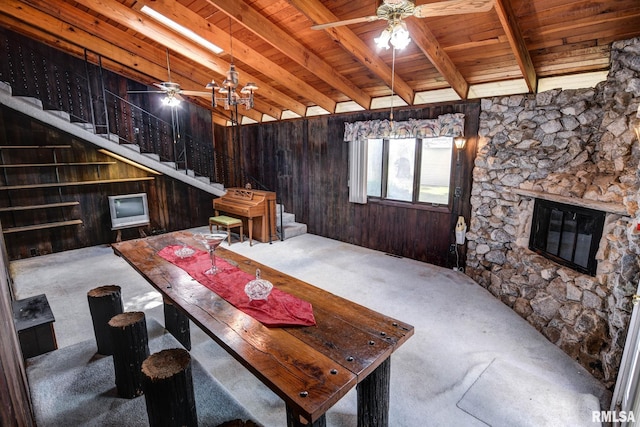107 E Harrison St, Edinburg, IL 62531 - living area with carpet floors, stairway, a wooden ceiling with exposed beams, ceiling fan, and wooden walls