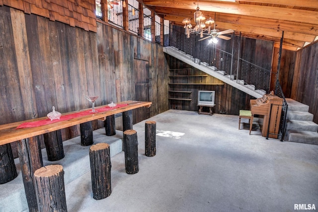 107 E Harrison St, Edinburg, IL 62531 - below grade area featuring stairs, carpet, wood walls, and a chandelier