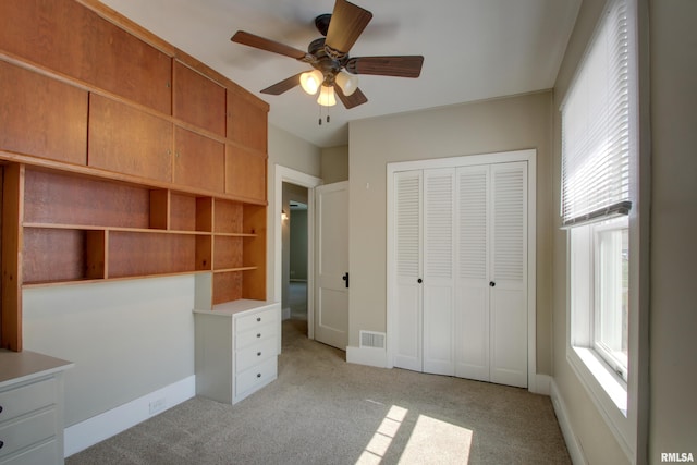 1512 Locust St, Quincy, IL 62301 - unfurnished bedroom with a closet, light colored carpet, and ceiling fan