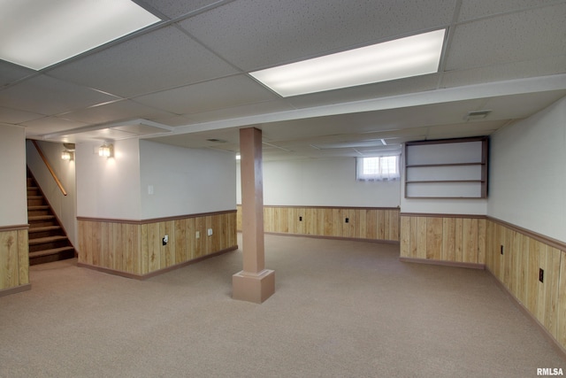 1512 Locust St, Quincy, IL 62301 - below grade area featuring a wainscoted wall, wood walls, a drop ceiling, stairs, and carpet flooring