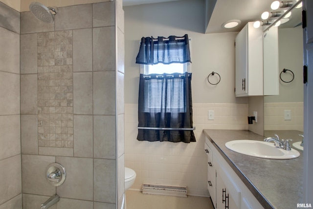 1512 Locust St, Quincy, IL 62301 - bathroom with tile walls, vanity, a wainscoted wall, and washtub / shower combination