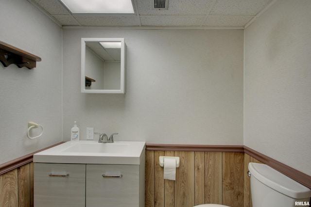 1512 Locust St, Quincy, IL 62301 - half bathroom featuring vanity, a drop ceiling, and a wainscoted wall