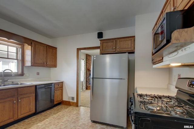 1512 Locust St, Quincy, IL 62301 - kitchen with appliances with stainless steel finishes, brown cabinetry, and light countertops