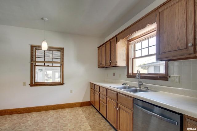 1512 Locust St, Quincy, IL 62301 - kitchen featuring dishwasher, light countertops, decorative light fixtures, and brown cabinets