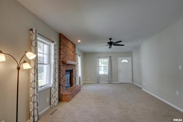 1512 Locust St, Quincy, IL 62301 - unfurnished living room featuring a fireplace, carpet floors, and a ceiling fan
