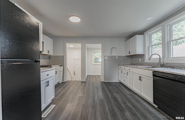 914 Pekin St, Lincoln, IL 62656 - kitchen with freestanding refrigerator, dishwashing machine, plenty of natural light, dark wood-style floors, and recessed lighting