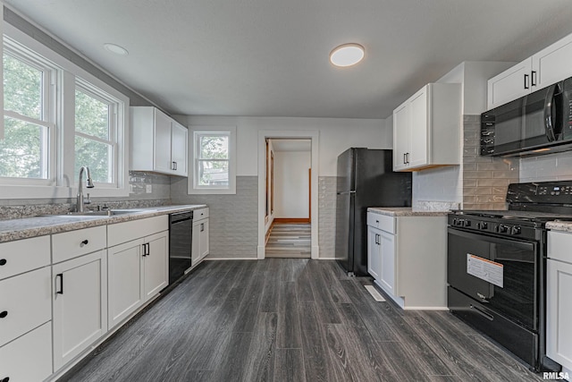 914 Pekin St, Lincoln, IL 62656 - kitchen featuring black appliances, dark wood-style floors, white cabinetry, and a wainscoted wall
