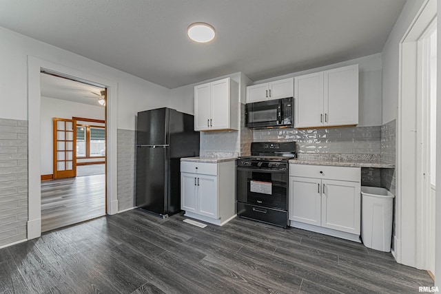 914 Pekin St, Lincoln, IL 62656 - kitchen with black appliances, dark wood-style floors, white cabinetry, tasteful backsplash, and light stone countertops
