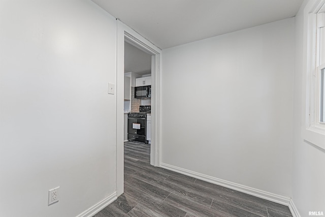 914 Pekin St, Lincoln, IL 62656 - hall with dark wood-type flooring and baseboards