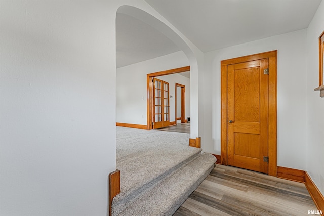 914 Pekin St, Lincoln, IL 62656 - hallway featuring arched walkways, wood finished floors, and stairs