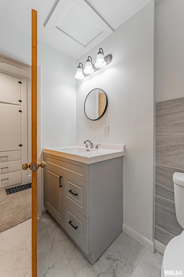 914 Pekin St, Lincoln, IL 62656 - bathroom featuring marble look tile flooring and vanity