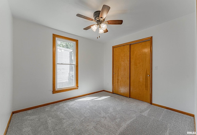 914 Pekin St, Lincoln, IL 62656 - unfurnished bedroom featuring carpet, a closet, and a ceiling fan