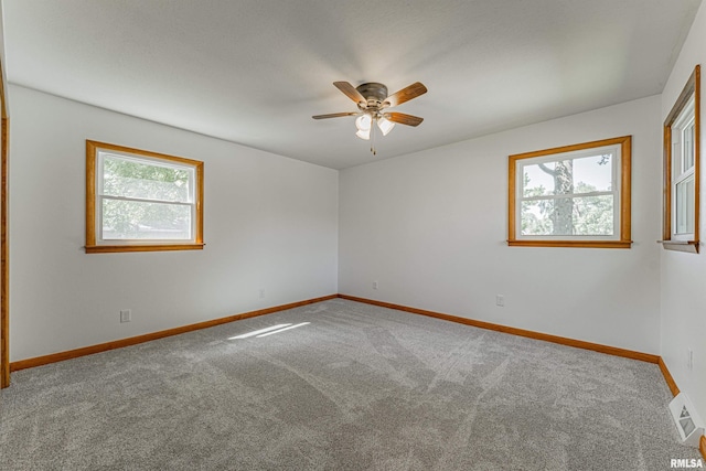 914 Pekin St, Lincoln, IL 62656 - carpeted empty room with plenty of natural light and ceiling fan