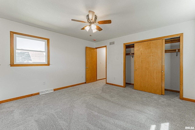 914 Pekin St, Lincoln, IL 62656 - unfurnished bedroom featuring carpet floors, a closet, and a ceiling fan