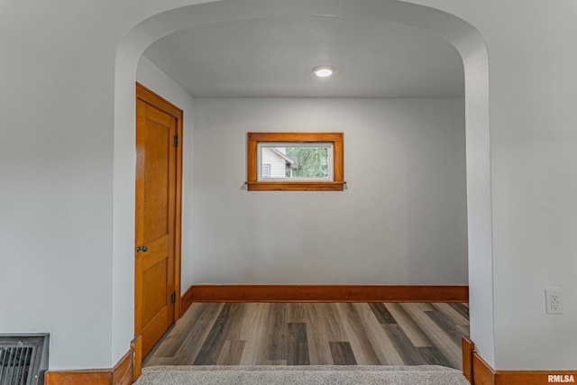 914 Pekin St, Lincoln, IL 62656 - empty room featuring arched walkways and wood finished floors