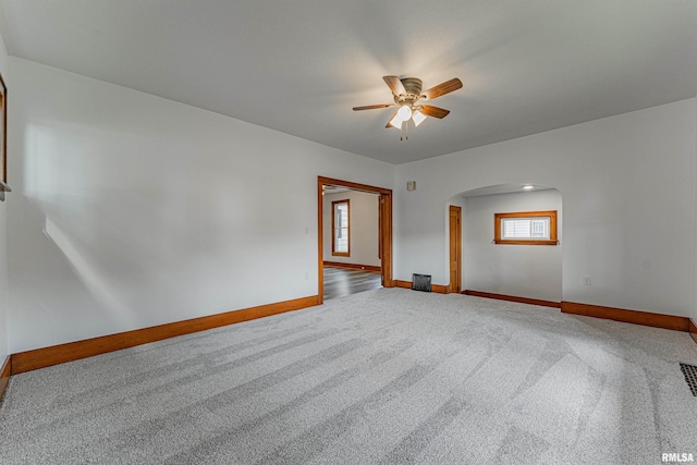 914 Pekin St, Lincoln, IL 62656 - carpeted empty room featuring arched walkways and ceiling fan