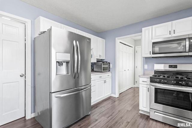 504 Windamere Dr, Sherman, IL 62684 - kitchen featuring appliances with stainless steel finishes, dark wood finished floors, white cabinetry, and light countertops