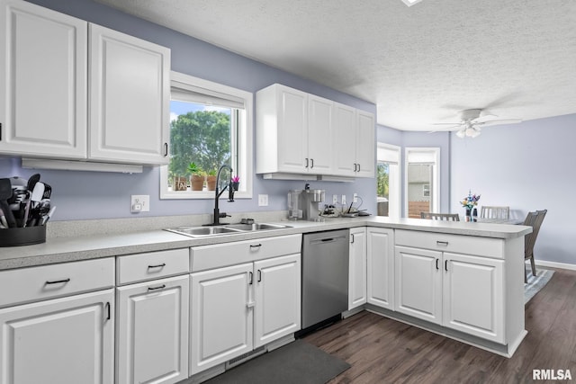 504 Windamere Dr, Sherman, IL 62684 - kitchen featuring stainless steel dishwasher, a peninsula, light countertops, dark wood-style flooring, and a textured ceiling