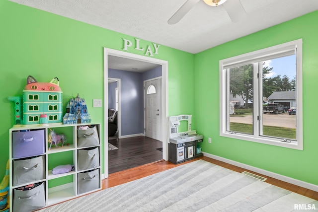 504 Windamere Dr, Sherman, IL 62684 - rec room with ceiling fan, wood finished floors, and a textured ceiling