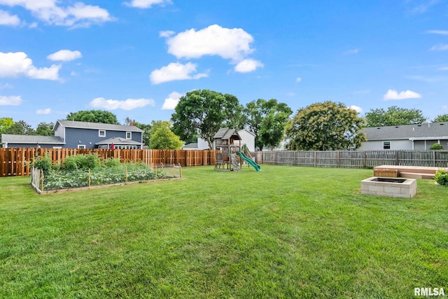 504 Windamere Dr, Sherman, IL 62684 - fenced backyard featuring a vegetable garden and a playground