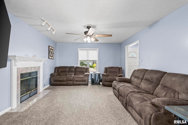 504 Windamere Dr, Sherman, IL 62684 - carpeted living area featuring ceiling fan, a tiled fireplace, and rail lighting