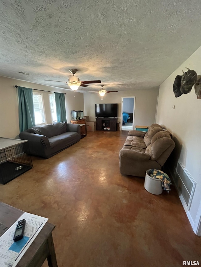 28 Albion St, Lynnville, IL 62650 - living area featuring concrete floors, a textured ceiling, and a ceiling fan