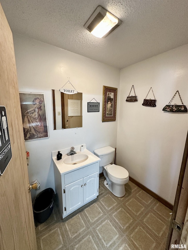 311 Main St, Meredosia, IL 62665 - half bathroom featuring vanity, a textured ceiling, and tile patterned floors