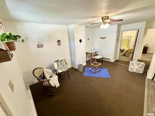 311 Main St, Meredosia, IL 62665 - living area featuring ceiling fan, a textured ceiling, and a baseboard heating unit
