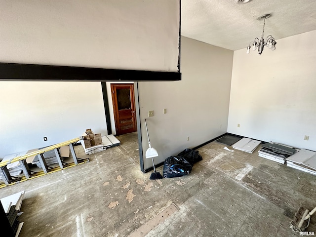 311 Main St, Meredosia, IL 62665 - empty room with a chandelier and a textured ceiling