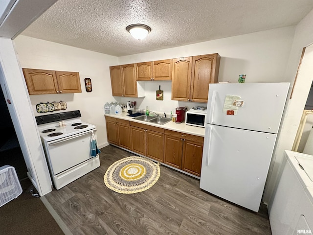 311 Main St, Meredosia, IL 62665 - kitchen featuring white appliances, dark wood-type flooring, light countertops, brown cabinets, and washer / dryer