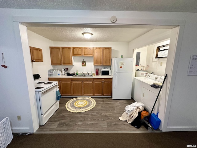 311 Main St, Meredosia, IL 62665 - kitchen featuring white appliances, dark wood-type flooring, light countertops, washer and clothes dryer, and brown cabinets