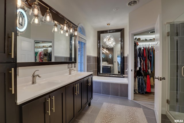 3005 Helens Ct, Quincy, IL 62305 - full bathroom with a spacious closet, tile patterned flooring, double vanity, and a garden tub