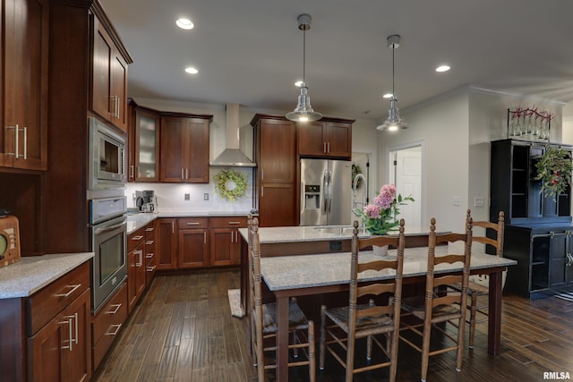 3005 Helens Ct, Quincy, IL 62305 - kitchen with appliances with stainless steel finishes, wall chimney range hood, crown molding, dark wood-style floors, and a breakfast bar area